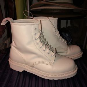 All white lace-up Dr. Martens.